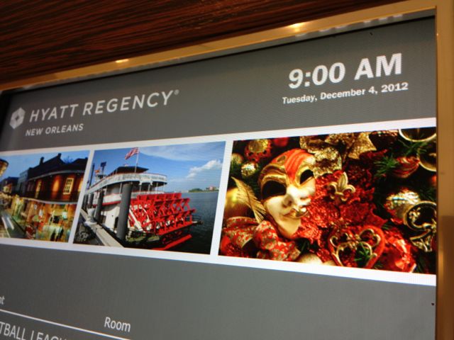 Hyatt Regency events board displays the time and date at the top