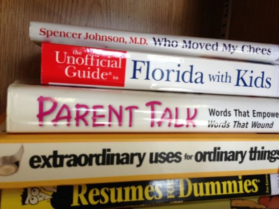 Stack of educational books on bookshelf