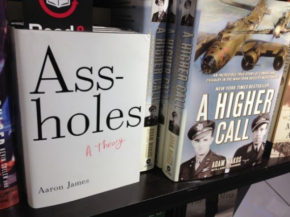 The book Assholes, in airport bookstand