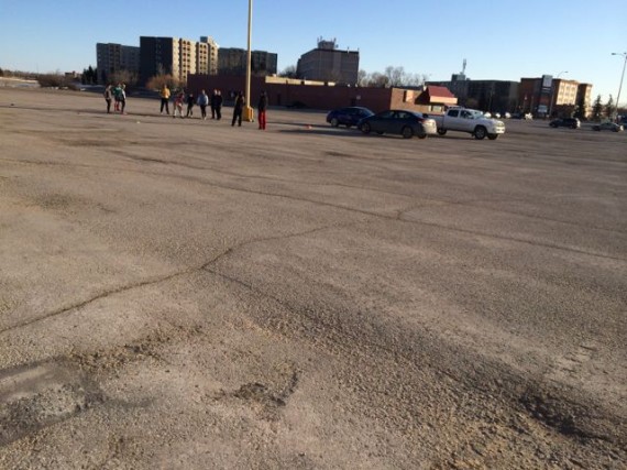 Middle aged adults conducting Rugby drills in Winnipeg parking lot