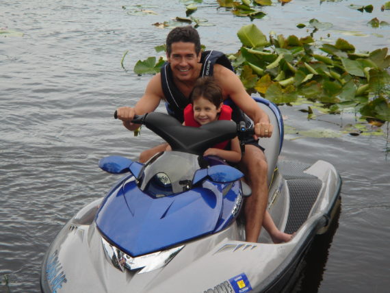 father and son on jet ski