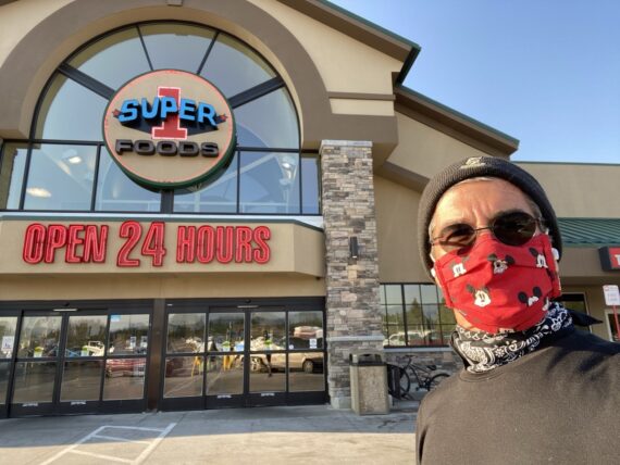 jeff noel, masked, in front of grocery store