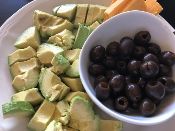 Plate with avocado, olives and cheese