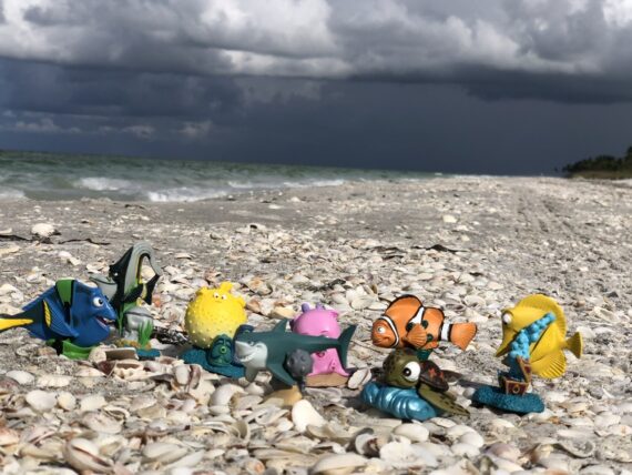 Toy Finding Nemo figurines at the beach