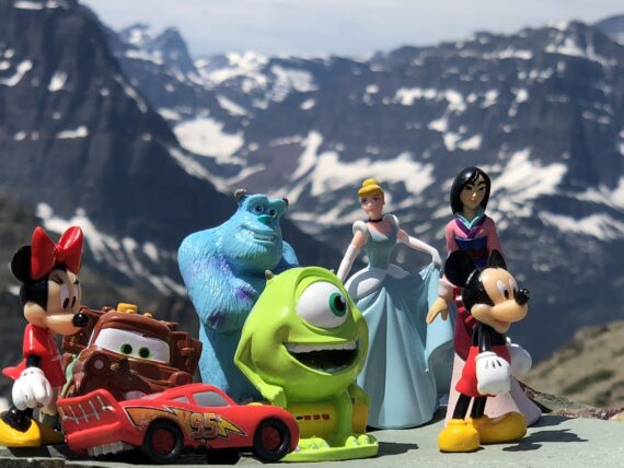 A handful of Disney character toys in the mountains
