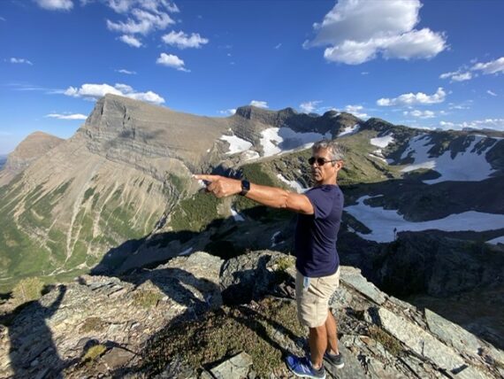 Disney speaker Jeff Noel pointing in the mountains