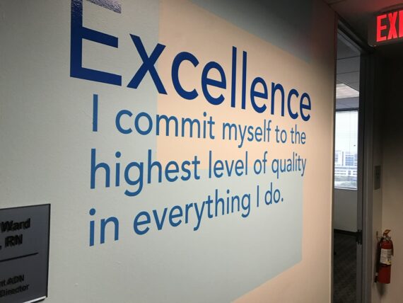 Quote about excellence on a corporate hallway wall
