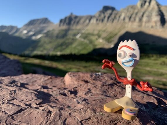 Disney toy character Forky in the mountains