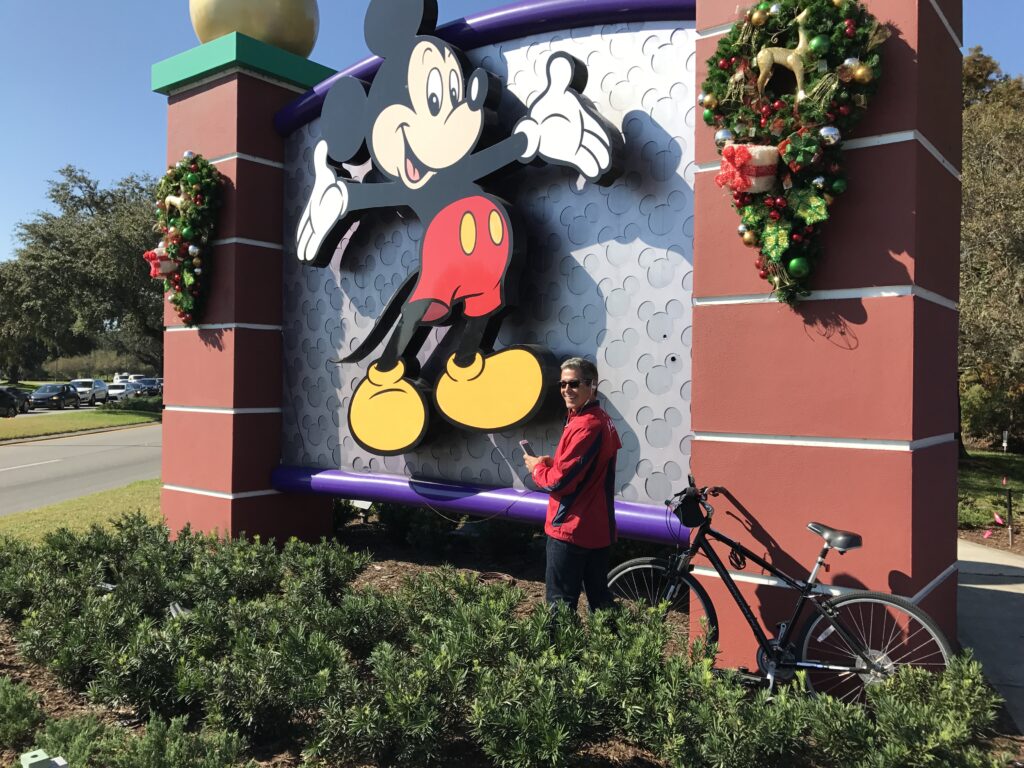 Disney employee culture author Jeff Noel writing at Disney Springs entrance