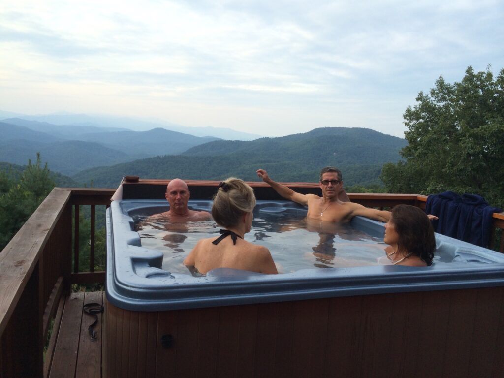 four people in a hot tub
