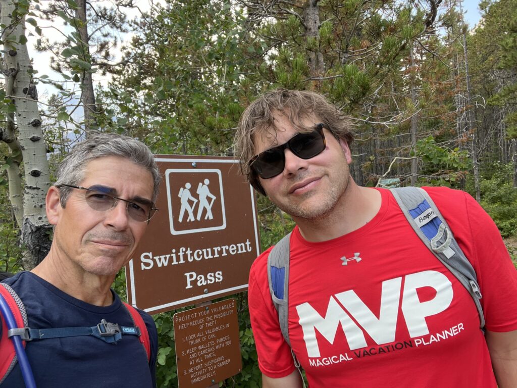 Two men at hiking trail sign