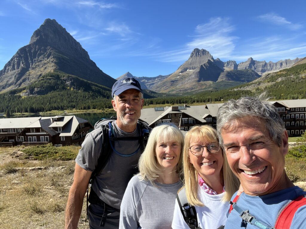 Four people by a mountain hotel