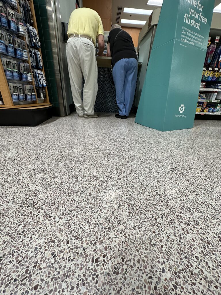 Two people at a drug store counter