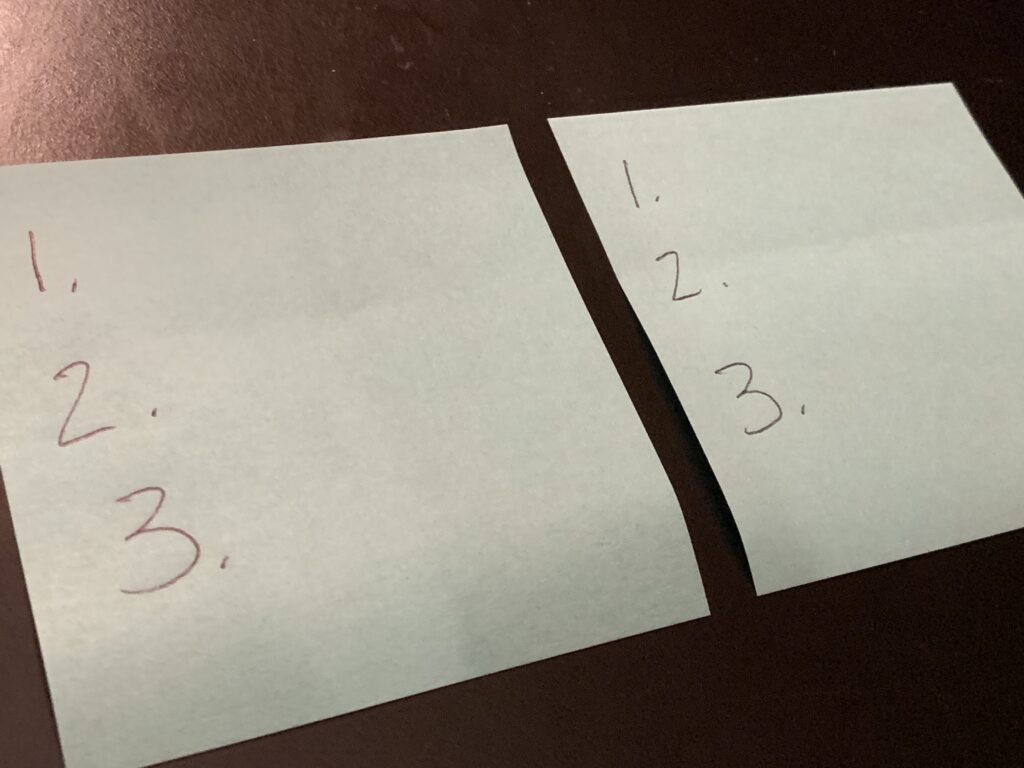 two posted notes with three  numbers