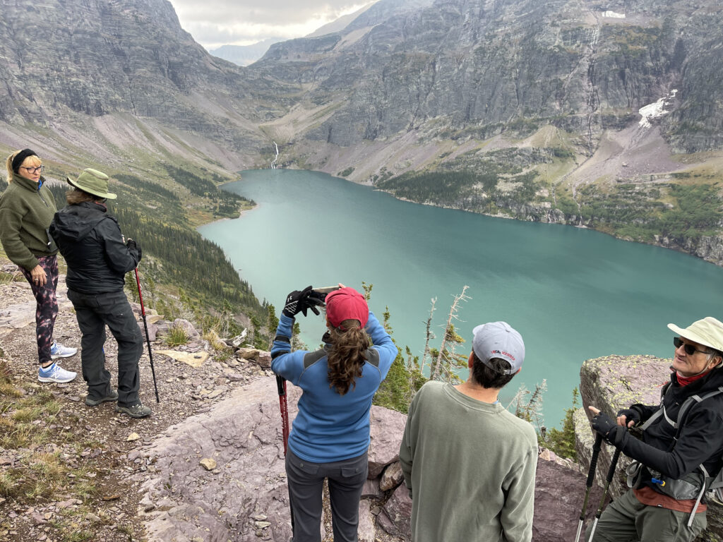 hikers near a mountain lake