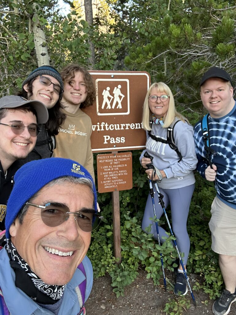 Family at trailhead sign in national park