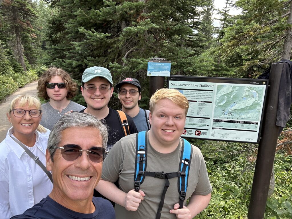 Family at trailhead sign