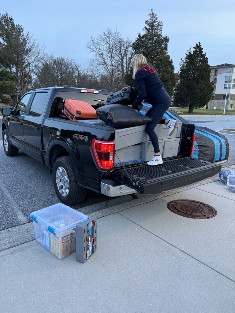 Pickup truck being loaded with college stuffs 