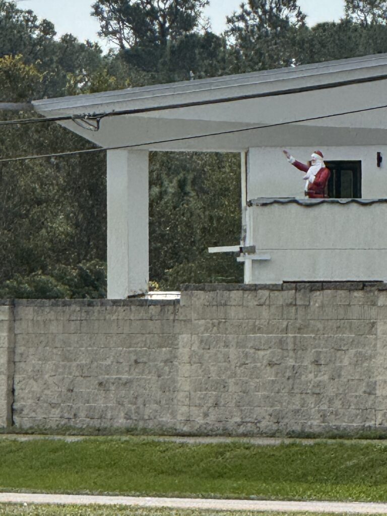 Santa character on a house deck