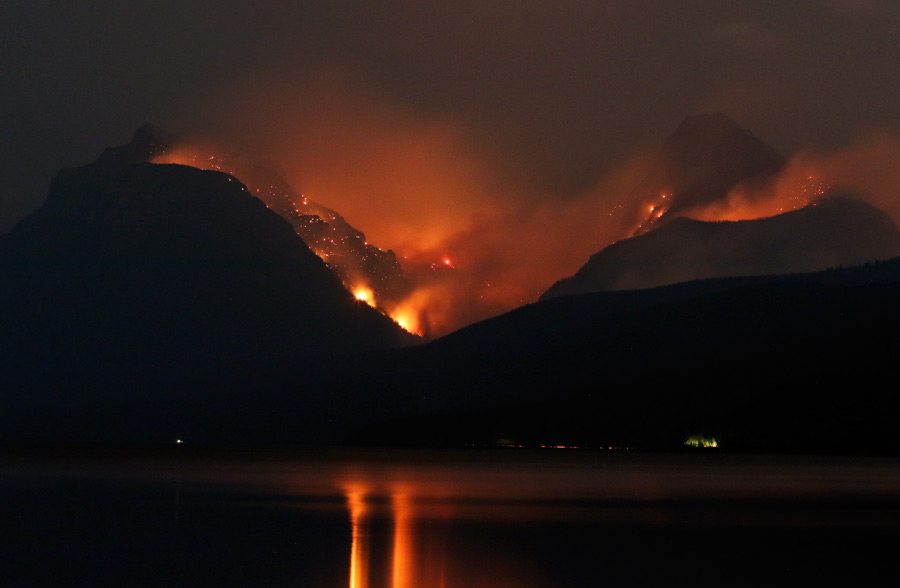 Mountain wildfire at night