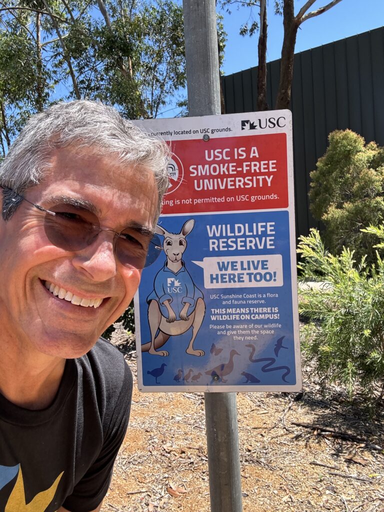 Man next to university sign