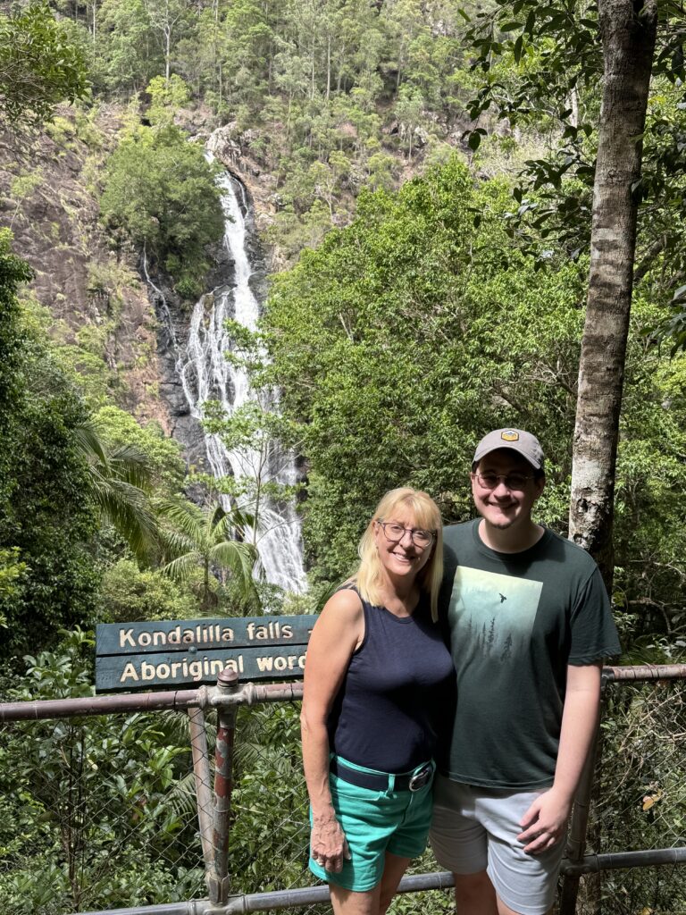 Two adults by water fall