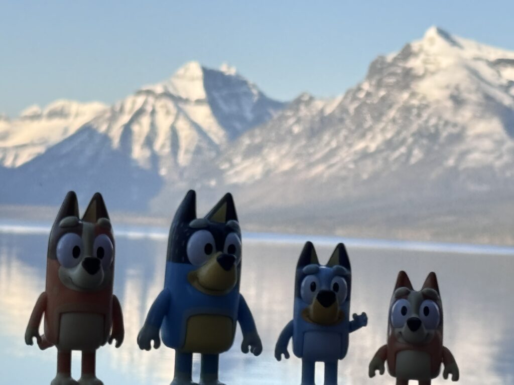 Bluey toy figurines at mountain lake