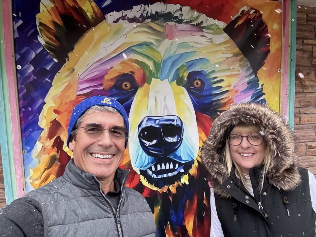 Couple next to Colorful bear art