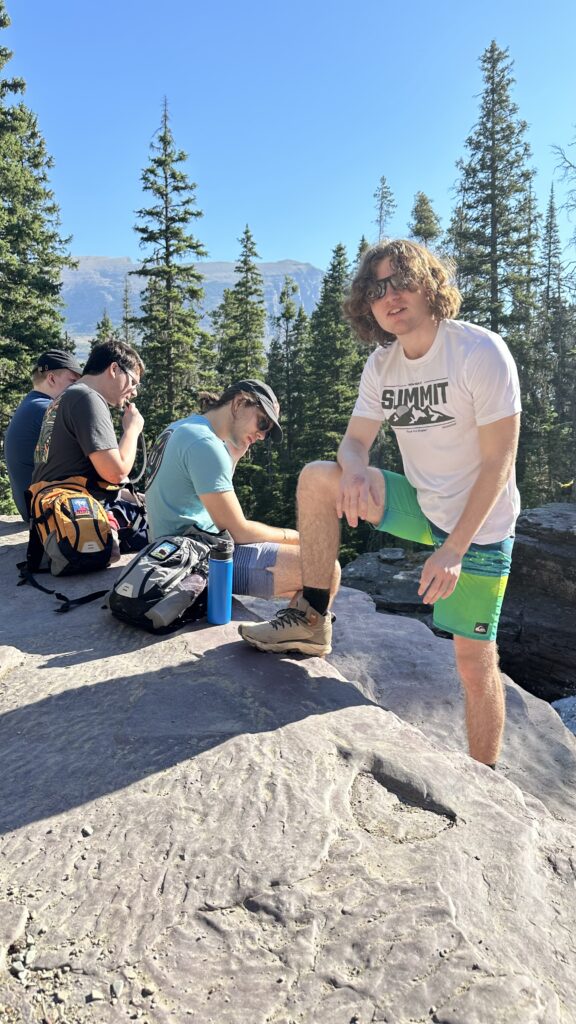 Four men sitting on a rock