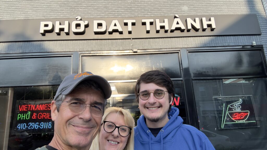 three people in front of restaurant