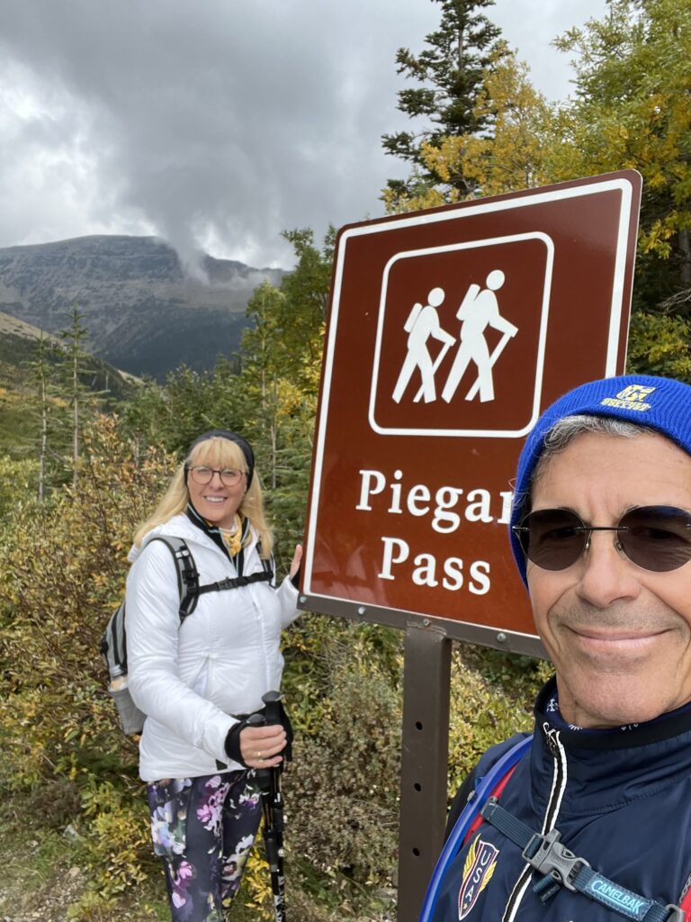 Two people at trailhead sign