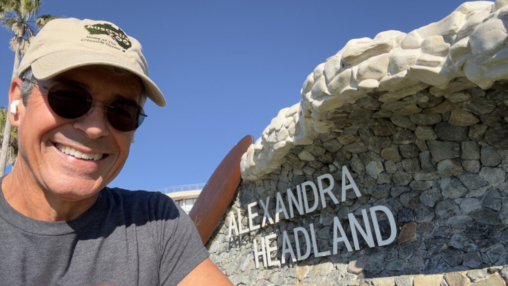 man next to stone town sign