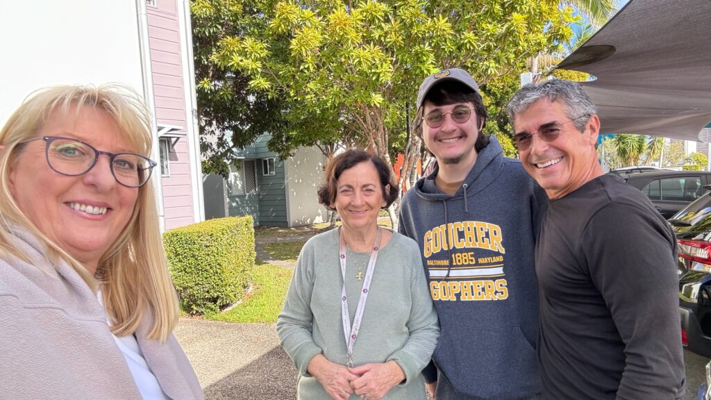 four adults posing in a photo