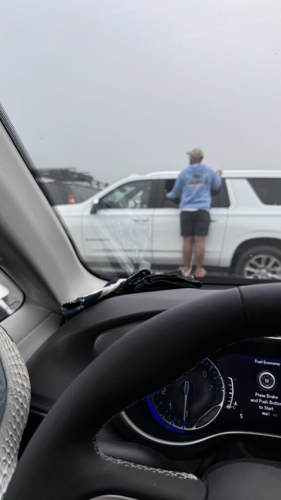 Man, standing on the side of a truck