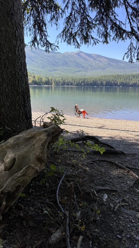 Woman sitting by lake