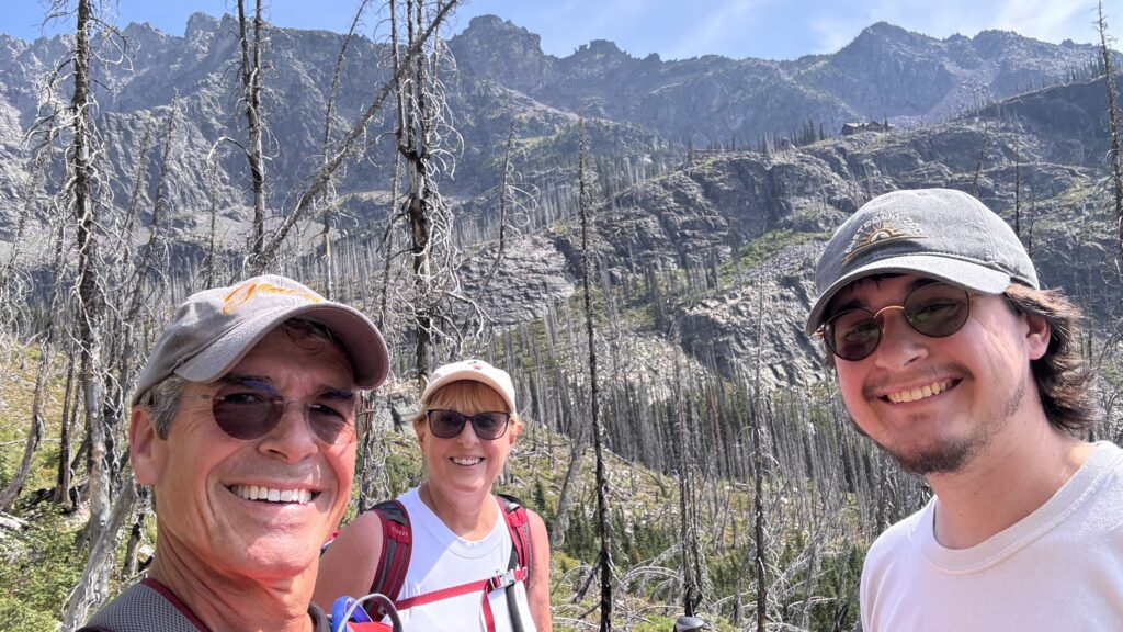 three people in the mountains