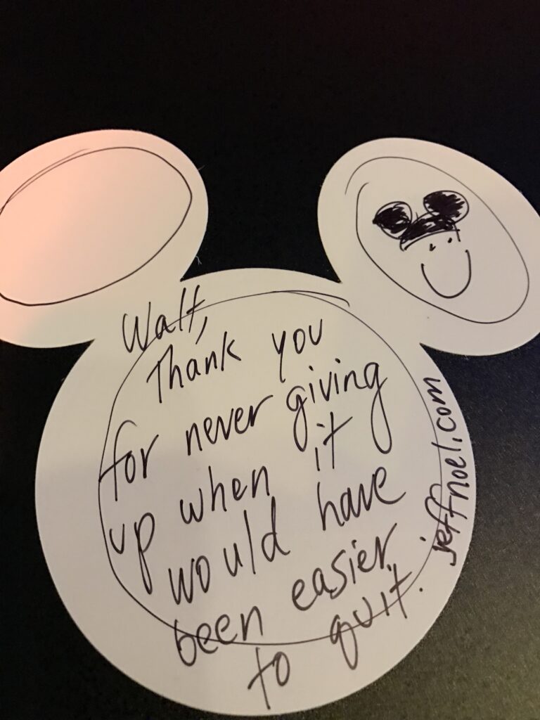 handwritten note on white Mickey Mouse head sticker